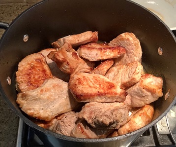 Pork chops over onions on stove
